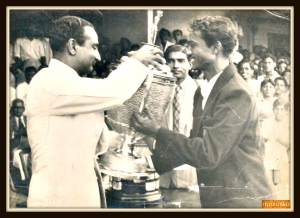 Pappa,  Mr. Ram Rege ,(on the right), in his college days, as the Captain for the Bombay University Cricket Team, receiving the winning trophy from the legendary cricketer Vijay Merchant